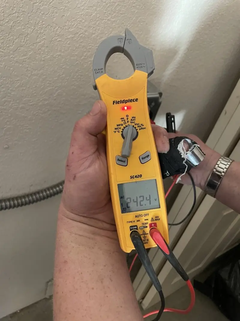 Voltage testing with clamp meter during Whole House Surge Protector in Sulphur Springs